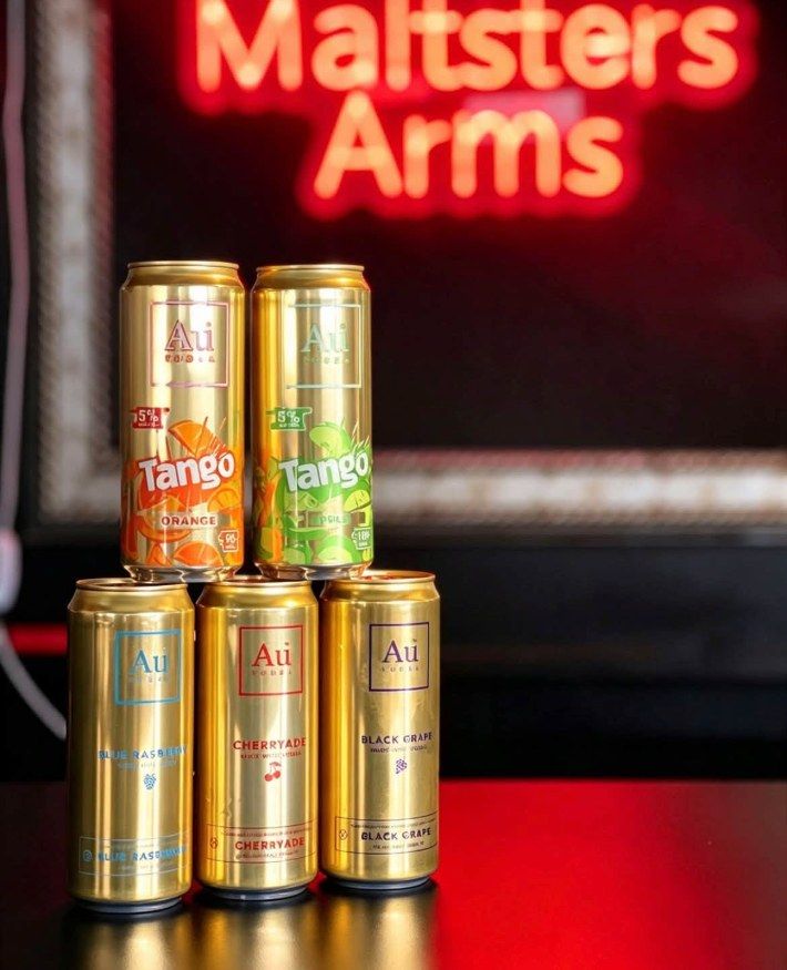Cans stacked under the Maltsters Arms neon sign